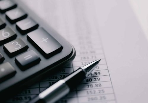Calculator and stationery items on the table. Accounting concept